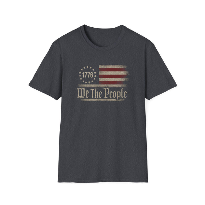 Dark heather unisex t-shirt with a distressed vintage Betsy Ross flag and old-style blackletter text reading We The People with 1776 in the star circle