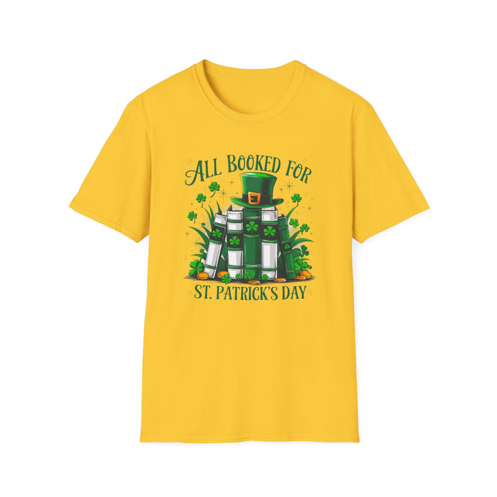 Daisy yellow unisex t-shirt with an illustrated stack of green books topped with a leprechaun hat surrounded by shamrocks and the text All Booked for St. Patrick&