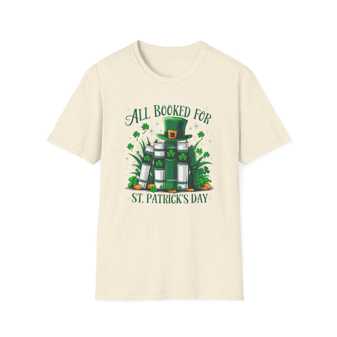Natural unisex t-shirt with an illustrated stack of green books topped with a leprechaun hat surrounded by shamrocks and the text All Booked for St. Patrick&
